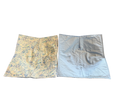 Two fabric swatches, one with a yellow and blue pattern and the other plain light blue, on a white background.