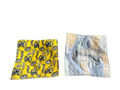 Two square fabrics, one yellow with black patterns and one tie-dye, on a white background.