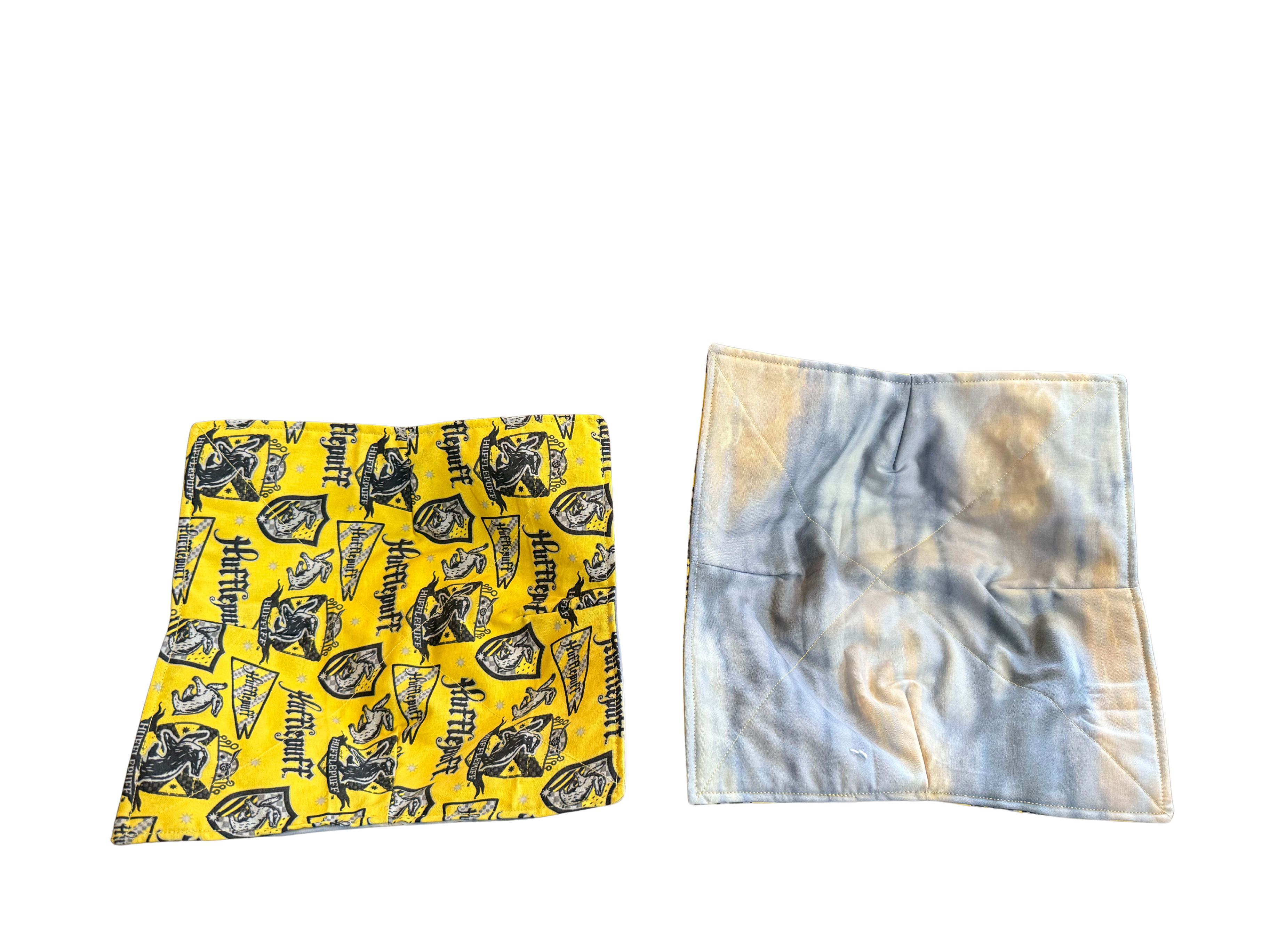Two square fabrics, one yellow with black patterns and one tie-dye, on a white background.