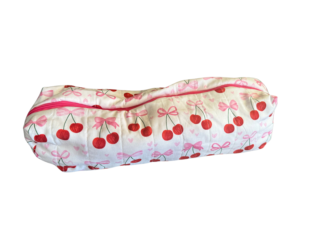 long zippered bag with cherry and bow pattern on a white background