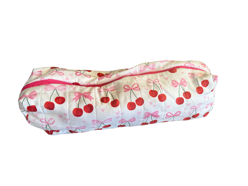 long zippered bag with cherry and bow pattern on a white background