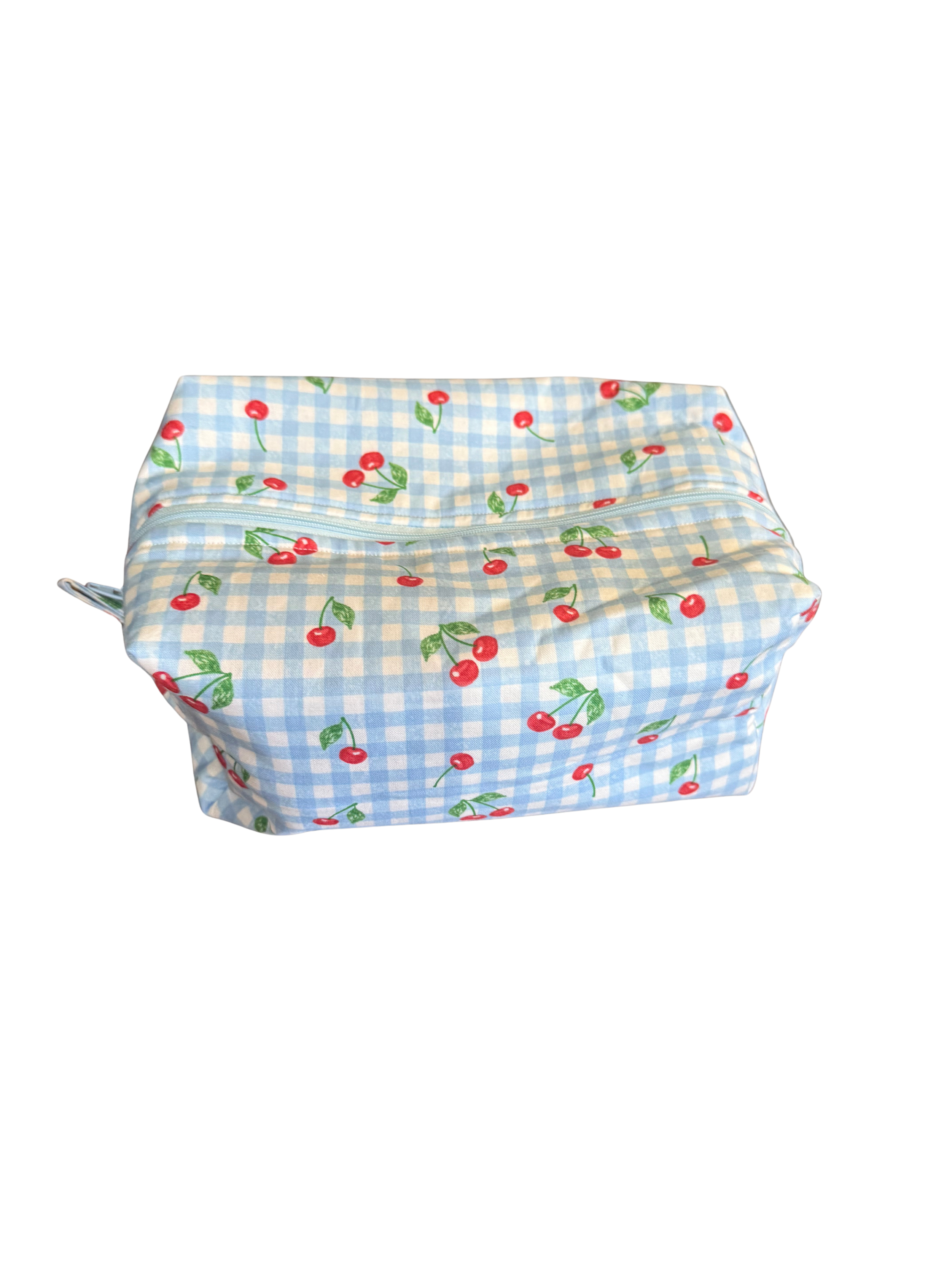 Blue checkered bag with red cherries on a white background