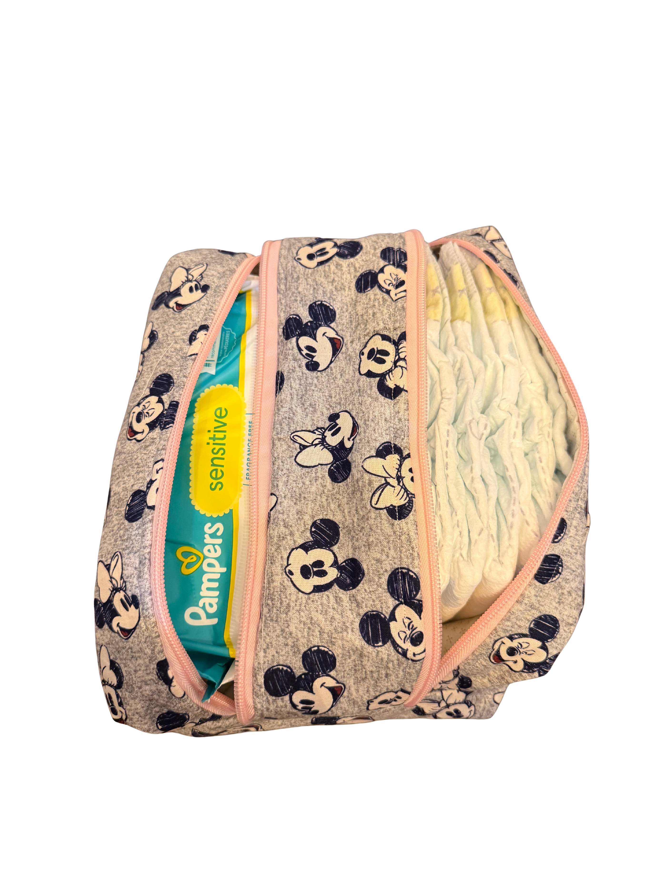 Diaper bag with Minnie Mouse pattern and Pampers sensitive wipes visible