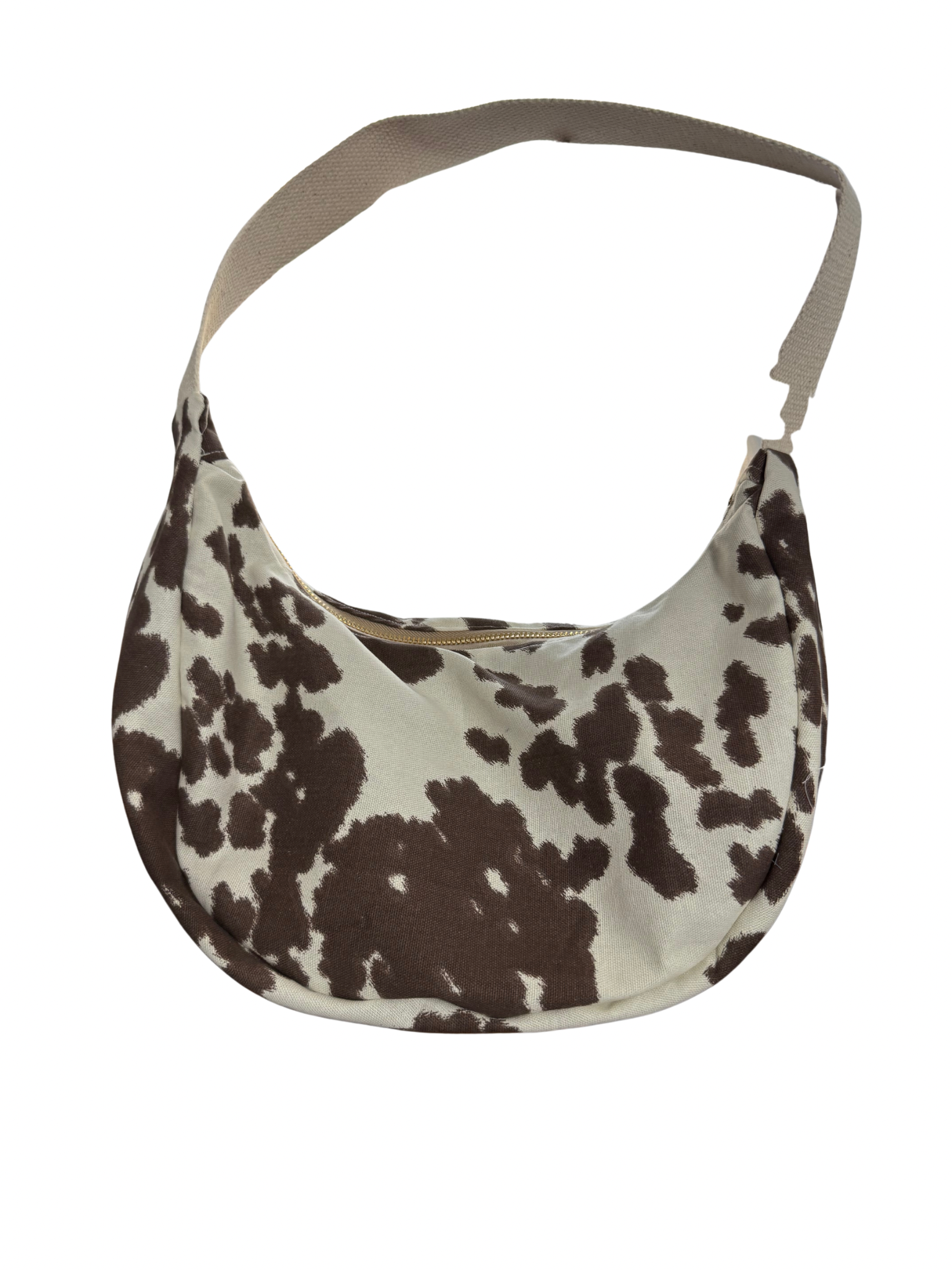 Hobo bag with brown and white cow print pattern on a white background