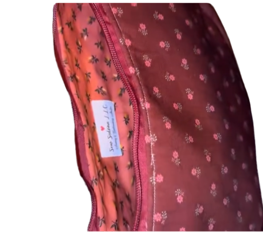 Red fabric with floral pattern interior and a visible label on a white background
