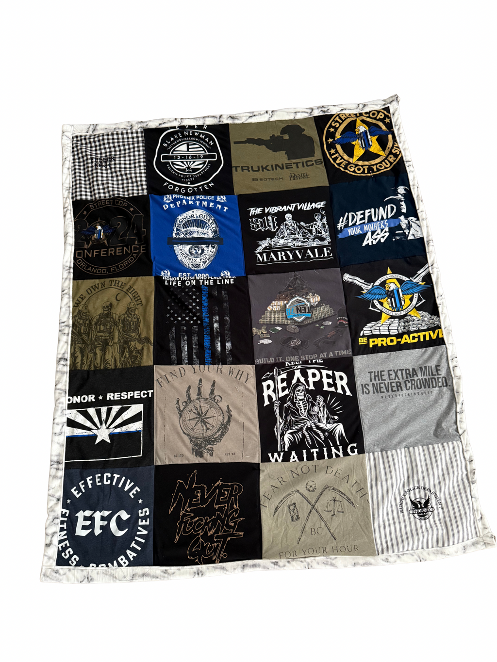 Quilt made from various t-shirt patches with different designs and text.
