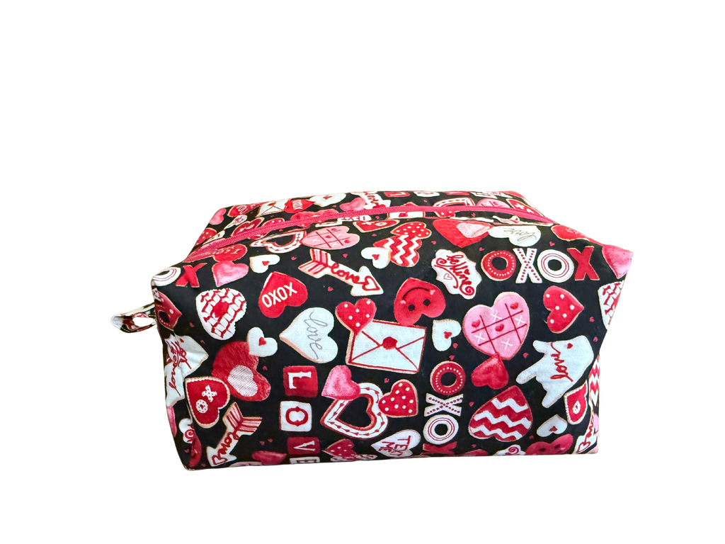 pouch with heart and love-themed designs on a black background
